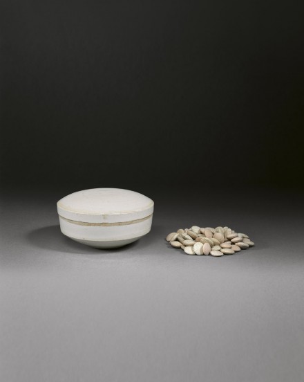 A GLAZED WHITE PORCELAIN BOX AND COVER WITH GAME COUNTERS