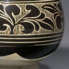 A CARVED ‘BLACK- AND WHITE’-GLAZED CIZHOU STONEWARE BOWL