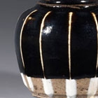 A MINIATURE WHITE-RIBBED BLACK-GLAZED STONEWARE JAR