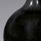 A ‘MIRROR BLACK’-GLAZED PORCELAIN BOTTLE VASE