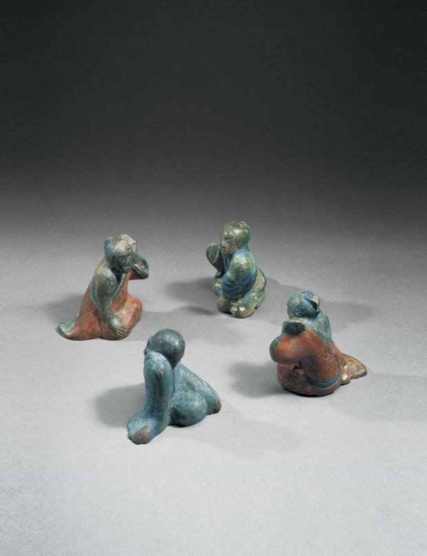 A Set of Four Painted Bronze Mat Weights in the Form of Liubo Players