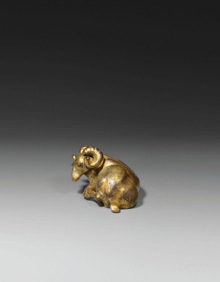 A GILT BRONZE RAM-FORM WEIGHT