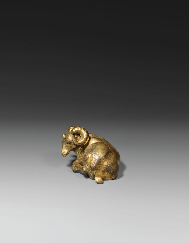 A GILT BRONZE RAM-FORM WEIGHT