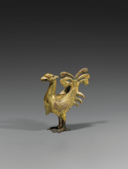 A GILT BRONZE FIGURE OF A PHOENIX