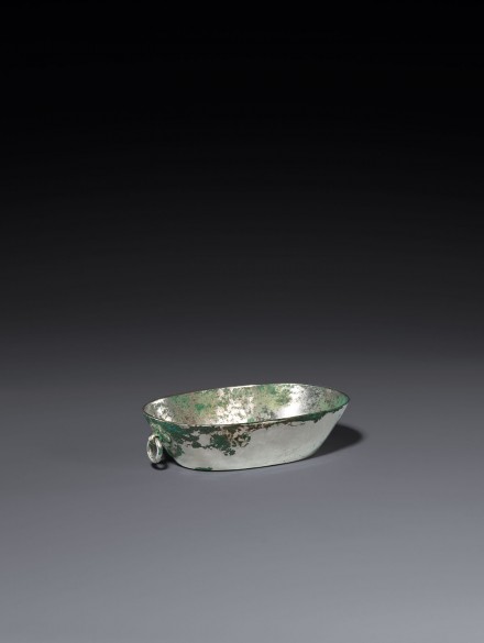 A SMALL OVAL SILVER BASIN WITH RING HANDLE