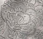 A SILVER DISH WITH CHASED FOLIATE DECORATION