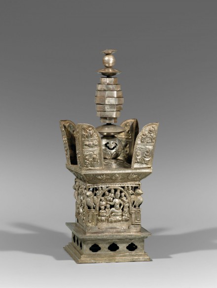 AN OPENWORK AND REPOUSSÉ SILVER VOTIVE STUPA