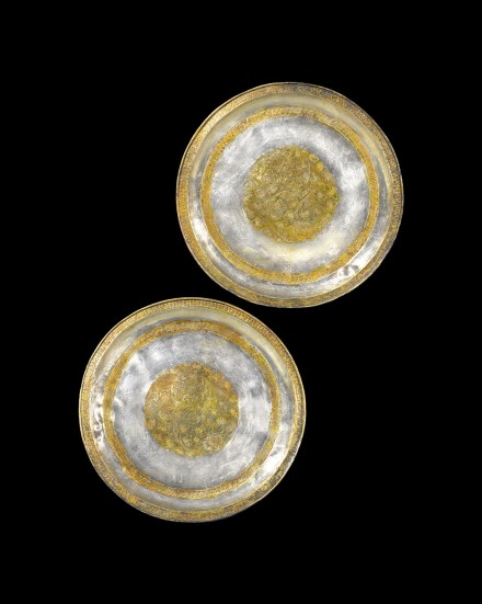 A PAIR OF CHASED AND PARCEL-GILT SILVER DISHES