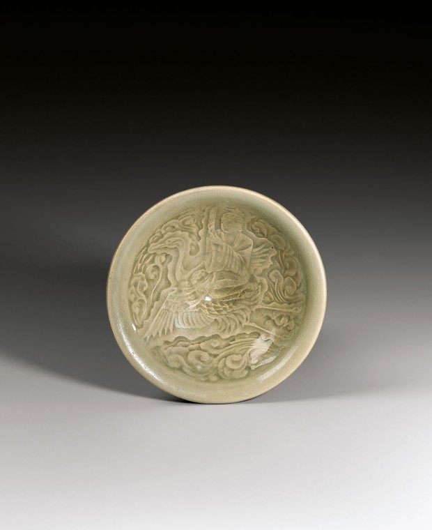 A YAOZHOU CELADON BOWL MOULDED WITH A DAOIST IMMORTAL RIDING ON A CRANE