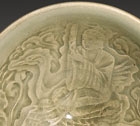 A YAOZHOU CELADON BOWL MOULDED WITH A DAOIST IMMORTAL RIDING ON A CRANE