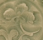 A CARVED YAOZHOU CELADON SMALL DISH