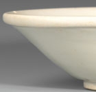 A GLAZED WHITE PORCELAIN SHALLOW BOWL