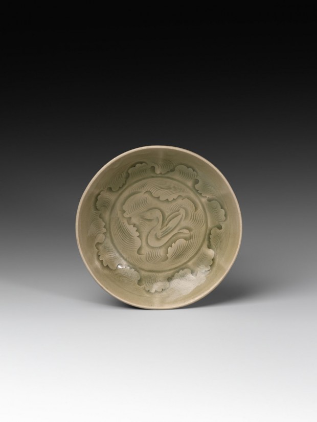 A CARVED YAOZHOU CELADON ‘DUCK IN WAVES’ SHALLOW BOWL