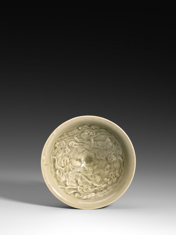 A YAOZHOU CELADON BOWL MOULDED WITH APSARAS