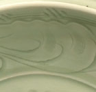 A LARGE CARVED LONGQUAN CELADON DISH