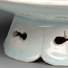 A YINGQING GLAZED PORCELAIN FLOWER-SHAPED WINECUP AND STAND