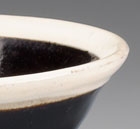 A BLACK-GLAZED TEABOWL WITH WHITE RIM