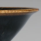 A SMALL BLACK-GLAZED TEABOWL