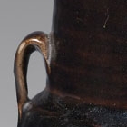 A BLACK-GLAZED STONEWARE JAR