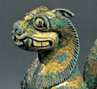 A GILT BRONZE FIGURE OF A GUARDIAN LION