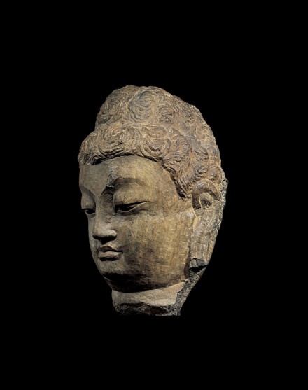 A MONUMENTAL STONE HEAD OF BUDDHA