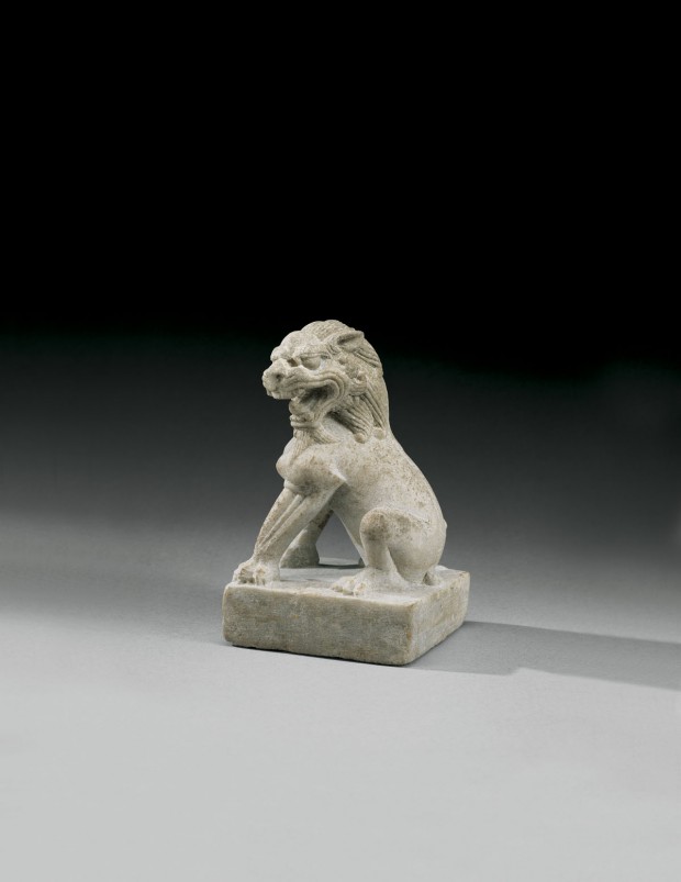 A SMALL LIMESTONE FIGURE OF A LION