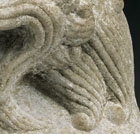 A SMALL LIMESTONE FIGURE OF A LION