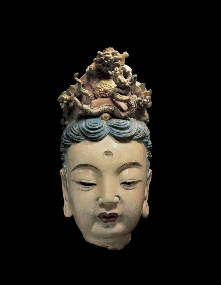 A LARGE PAINTED AND GILDED STUCCO HEAD OF A BODHISATTVA