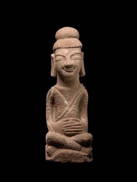 A RED SANDSTONE SEATED FIGURE OF THE BUDDHA