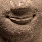 A RED SANDSTONE SEATED FIGURE OF THE BUDDHA