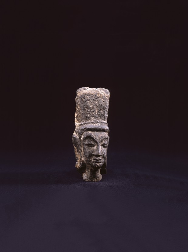 A SMALL DARK GRAY STONE RELIEF HEAD OF A BODHISATTVA