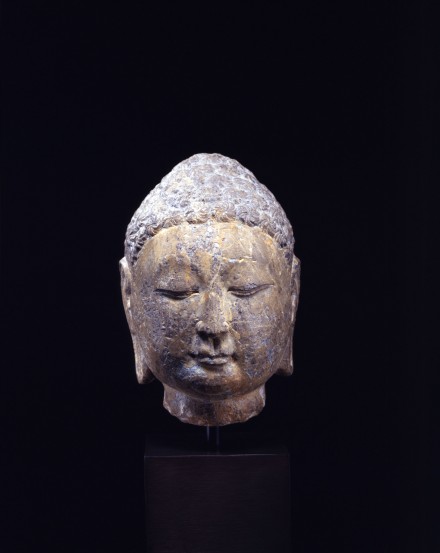 A GRAY LIMESTONE HEAD OF THE BUDDHA