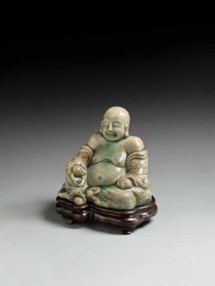 A LONGQUAN CELADON GLAZED STONEWARE FIGURE OF BUDAI