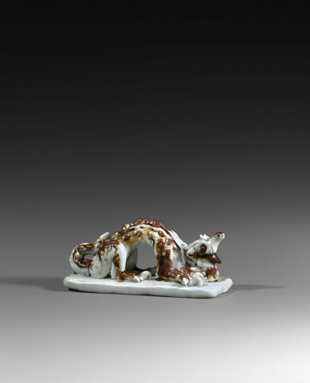 A QINGBAI GLAZED IRON-BROWN SPLASHED PORCELAIN DRAGON-FORM BRUSHREST