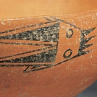 A NEOLITHIC RED POTTERY BOWL WITH PAINTED FISH DESIGN