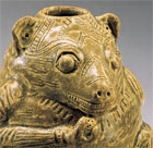 A YUEYAO GLAZED STONEWARE BEAR-FORM VESSEL