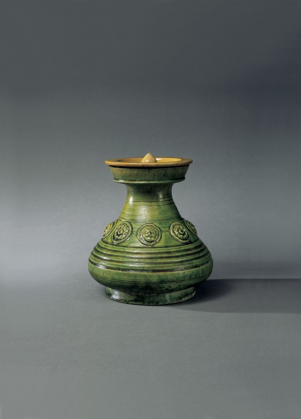 A GREEN-GLAZED POTTERY COVERED VASE WITH APPLIED MEDALLIONS