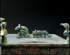 AN ARCHAIC BRONZE BOX ON WHEELED TIGERS