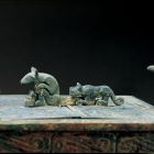 AN ARCHAIC BRONZE BOX ON WHEELED TIGERS