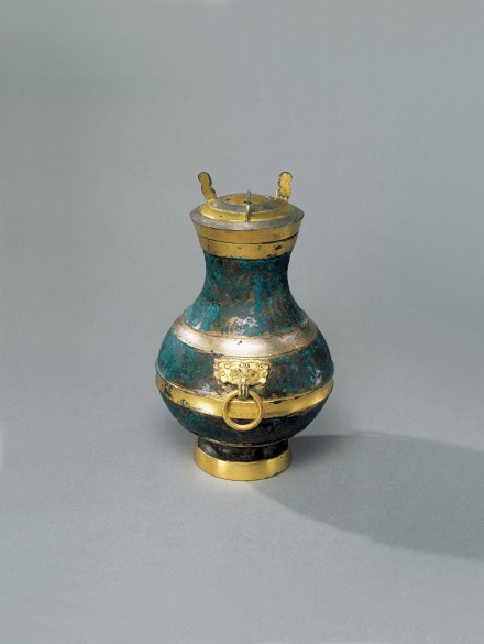 A GILDED AND SILVERED BRONZE COVERED VESSEL (HU)