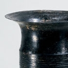 A NEOLITHIC BLACK POTTERY CUP ON HIGH FOOT