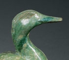 A LARGE IRIDESCENT GREEN-GLAZED POTTERY FIGURE OF A DUCK