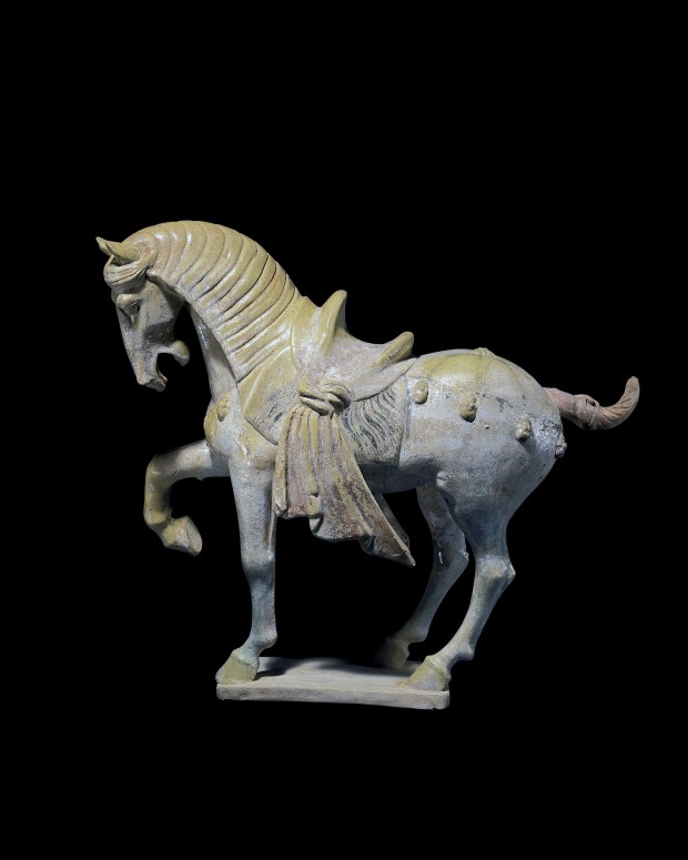 A GLAZED AND PAINTED POTTERY FIGURE OF A PRANCING HORSE