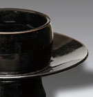 A BLACK-GLAZED STONEWARE CUPSTAND