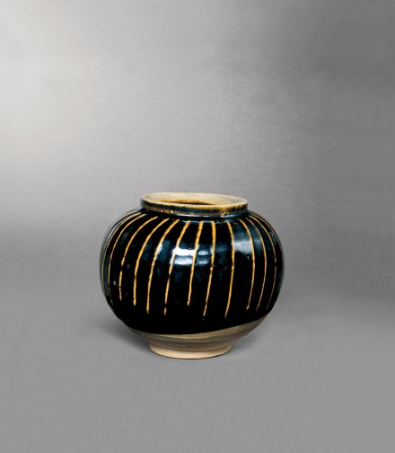 A WHITE-RIBBED BLACK-GLAZED GLOBULAR JAR