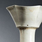 A TALL WHITE-GLAZED STONEWARE VASE