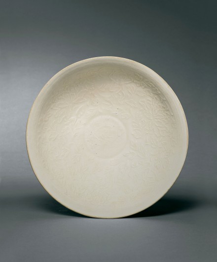 A LARGE MOULDED DINGYAO WHITE PORCELAIN ‘BOYS AND PEONIES’ BOWL