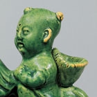 A GREEN-GLAZED POTTERY ‘BOY AND PHOENIX’ EWER