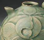 A CARVED YAOZHOU CELADON EWER