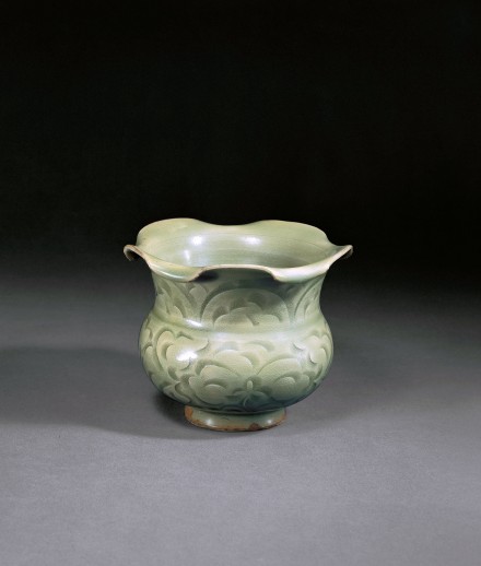 A CARVED YAOZHOU CELADON JAR WITH FOLIATE MOUTH (ZUN)